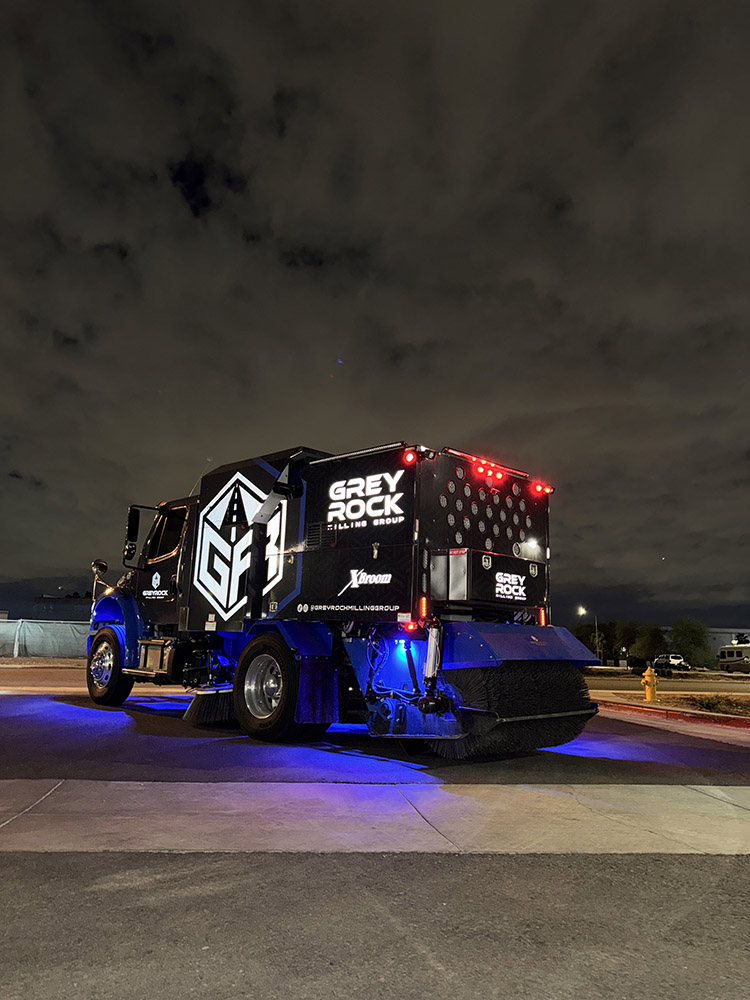 XBroom street sweeper performing asphalt milling cleanup on road construction site